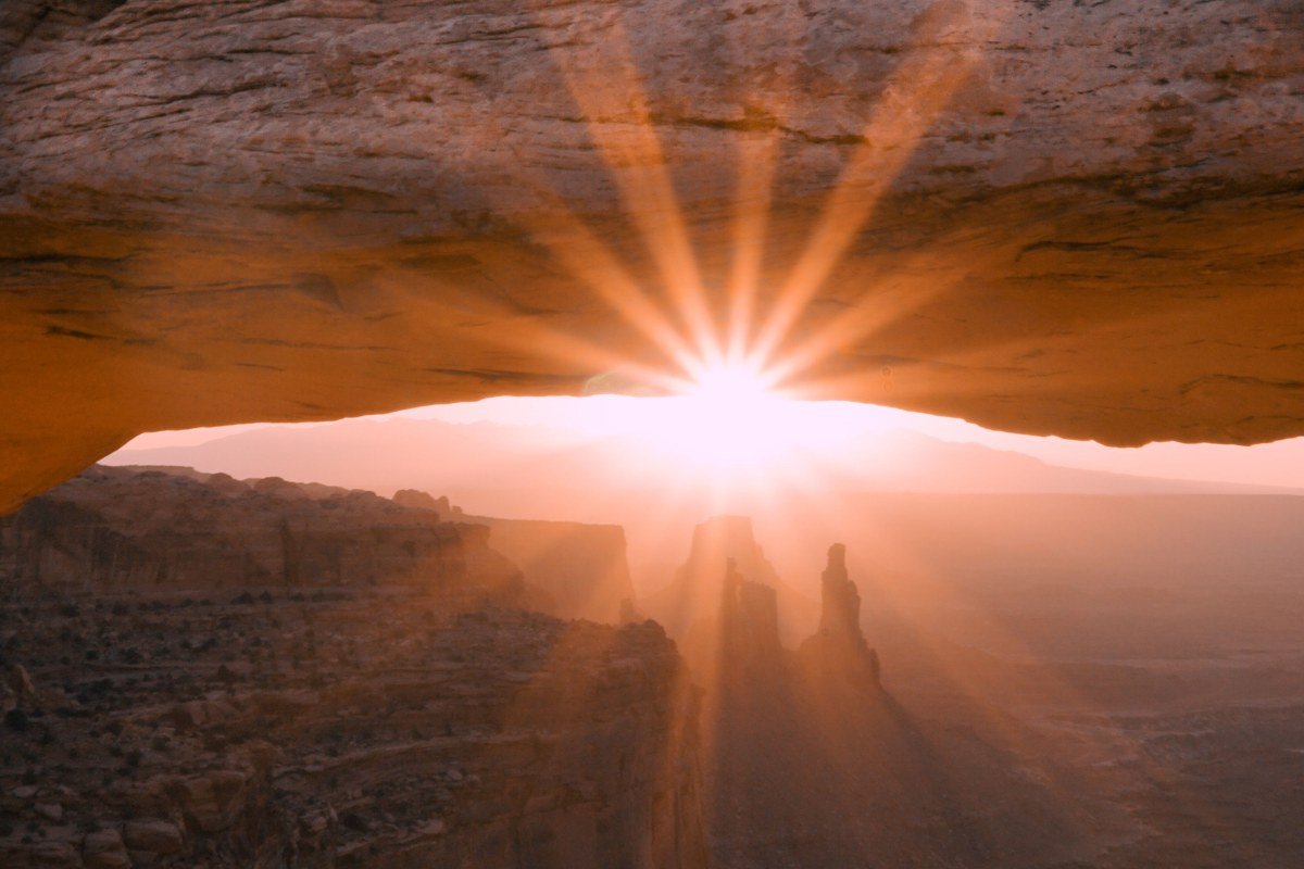 Canyonlands National Park Mesa Arch at sunrise with glowing orange rock frame