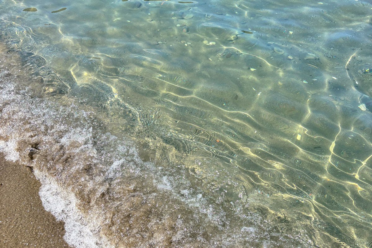 white sand cove at Stockton Island Apostle Islands with clear shallow water and pine forest shoreline