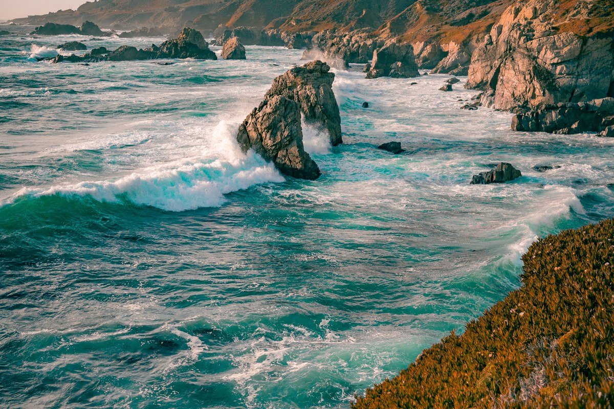 Bixby Bridge, Big Sur, California, concrete arch bridge over canyon with morning fog and ocean. Photo credit: placeholder, replace before publish