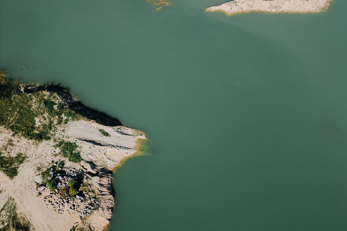 Sharps Chapel inlet in late September, blue-green water, rock bluff, one gravel boat ramp