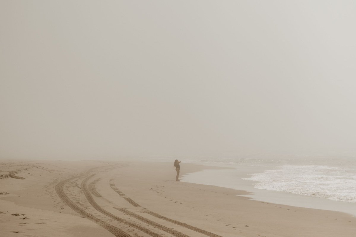Cape Kiwanda sandstone cliffs Pacific City Oregon with fog over the dory fleet
