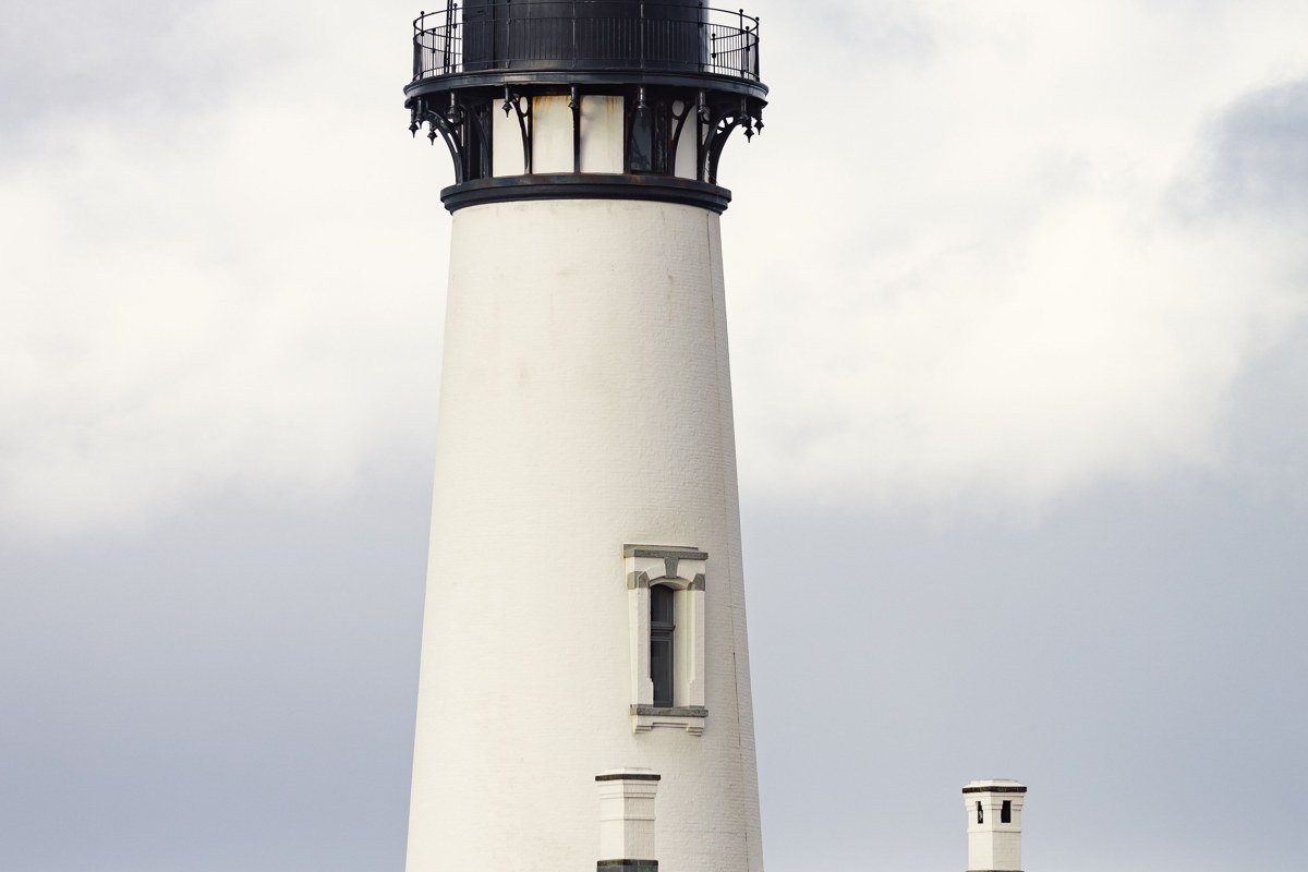 Yaquina Head Lighthouse Oregon coast fog around basalt sea stacks