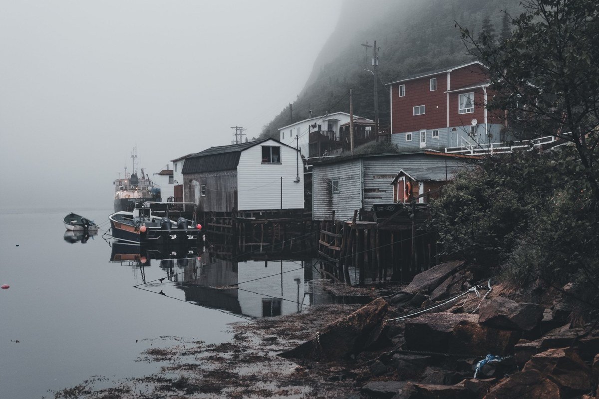 foggy harbor in Kittery Maine with lobster boats at low tide