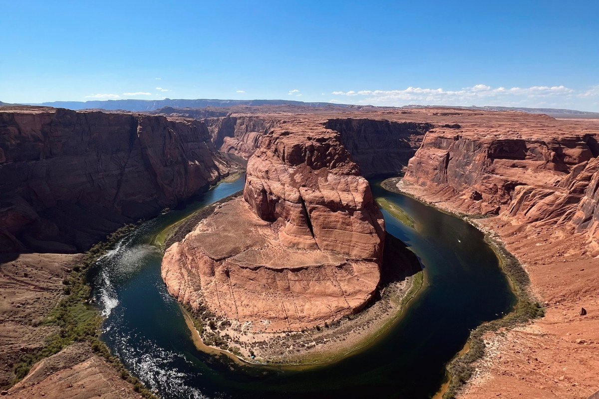 wide aerial view of red rock canyons and the Colorado River near Moab at sunset