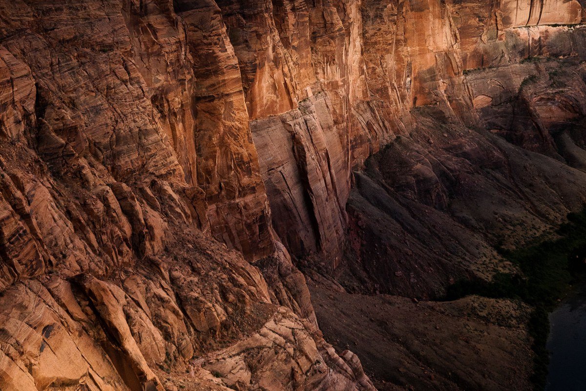 rafters dropping into a rapid in Westwater Canyon, red sandstone walls closing in on the Colorado River