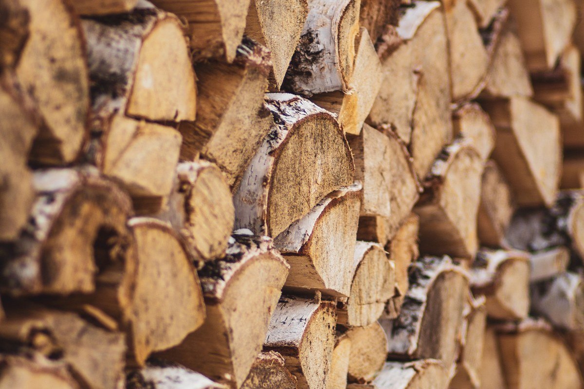stone fireplace with stacked firewood inside a Gatlinburg Tennessee log cabin, October evening light