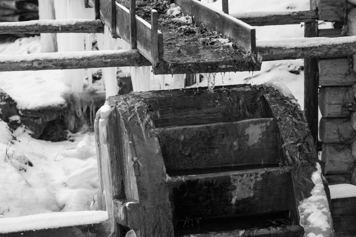 snowmelt creek rushing past a log cabin in Roaring Fork near Gatlinburg Tennessee in early spring