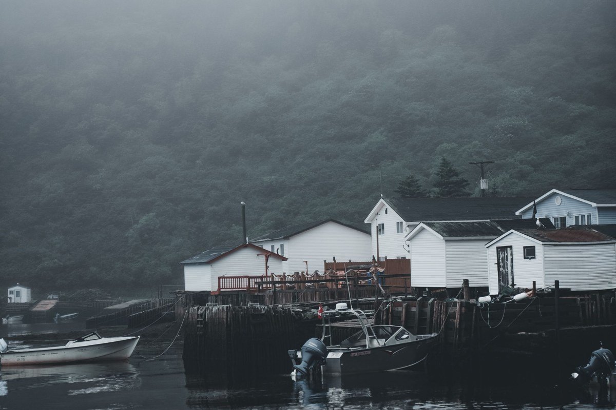 Monhegan Island Maine lighthouse and fog over car-free harbor village