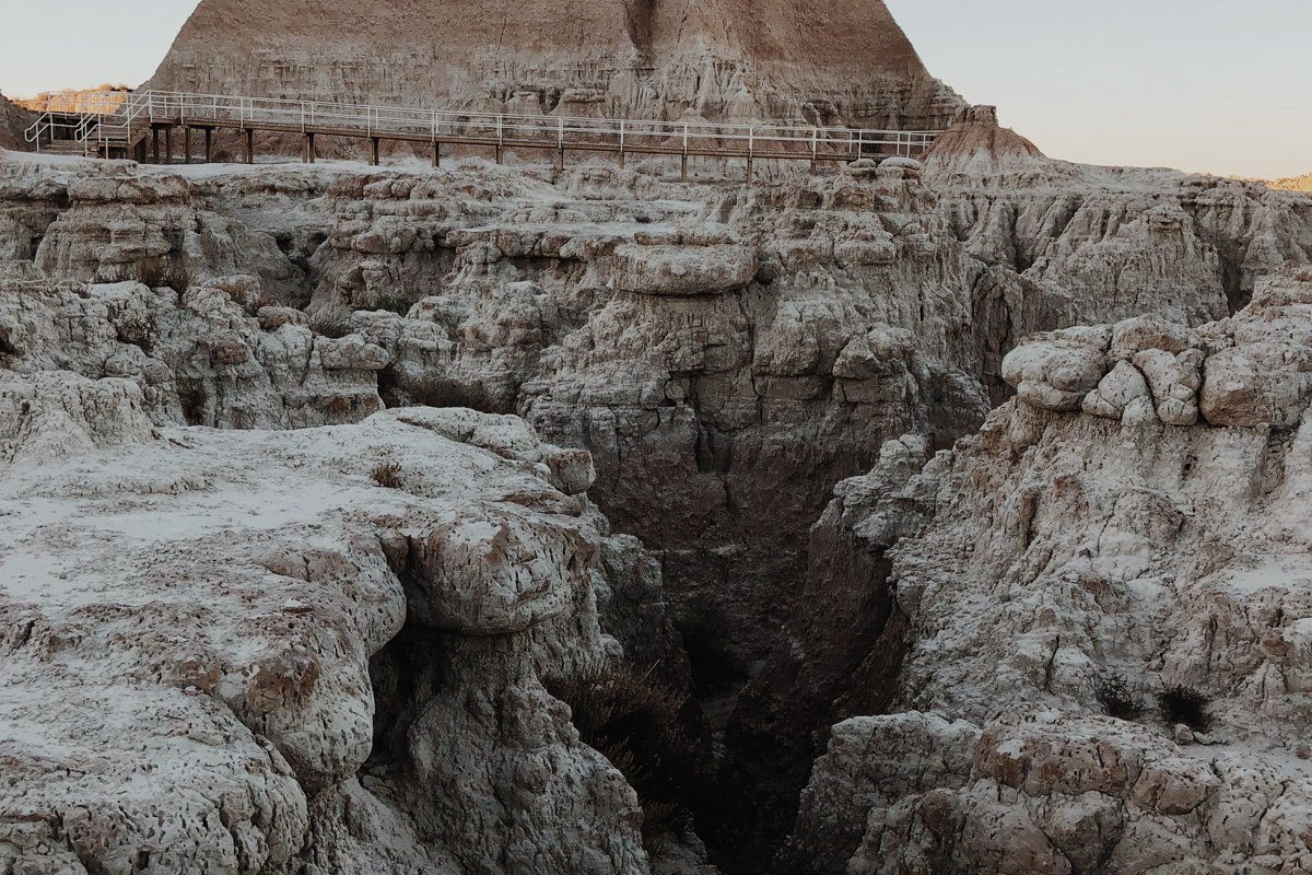 Door Trail Badlands South Dakota boardwalk leading into eroded canyon at sunrise