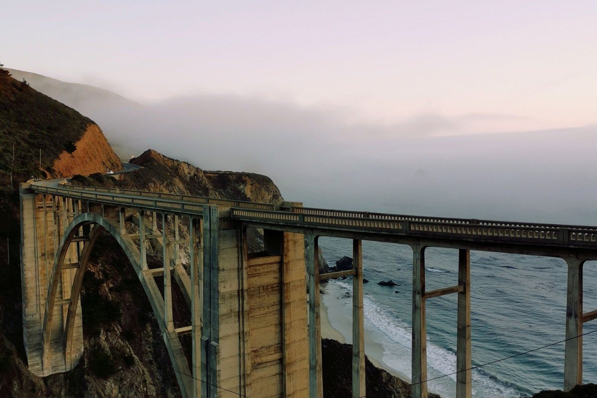 Bixby Bridge California arched concrete span above rocky cove and Pacific surf