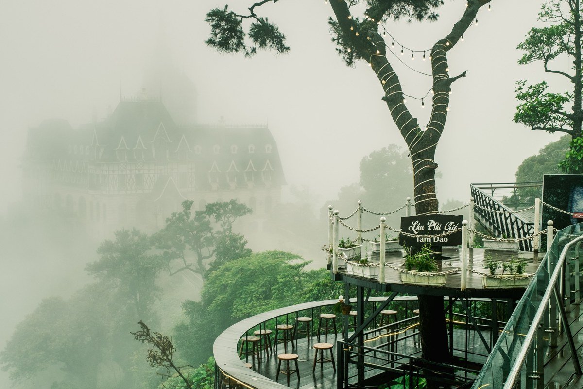 Nepenthe restaurant terrace Big Sur with fog rolling over cliffs below the deck