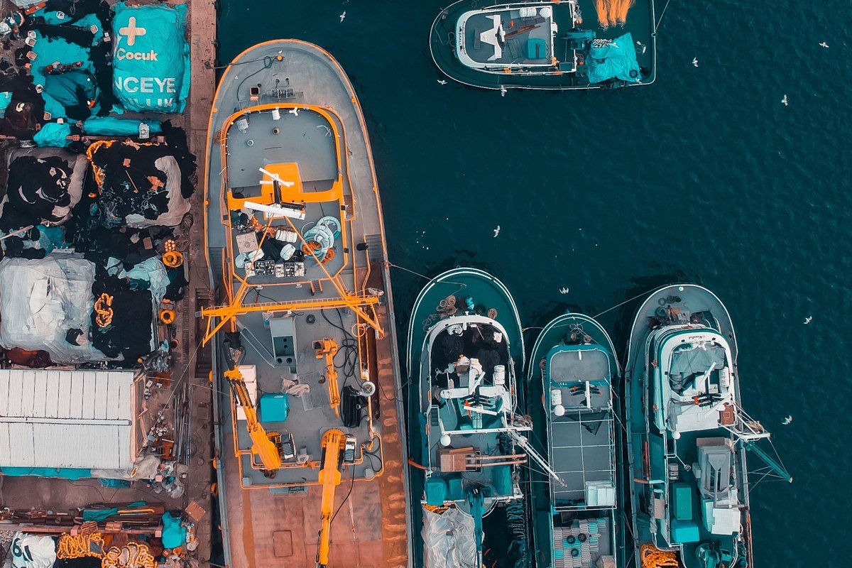 aerial view of a quiet Cape Cod harbor at sunrise with fishing boats and empty docks