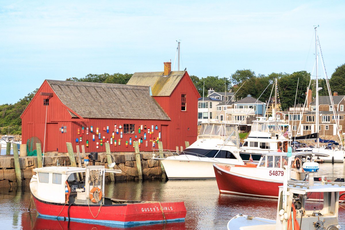 Woods Hole harbor drawbridge with research vessels and lobster boats at dusk