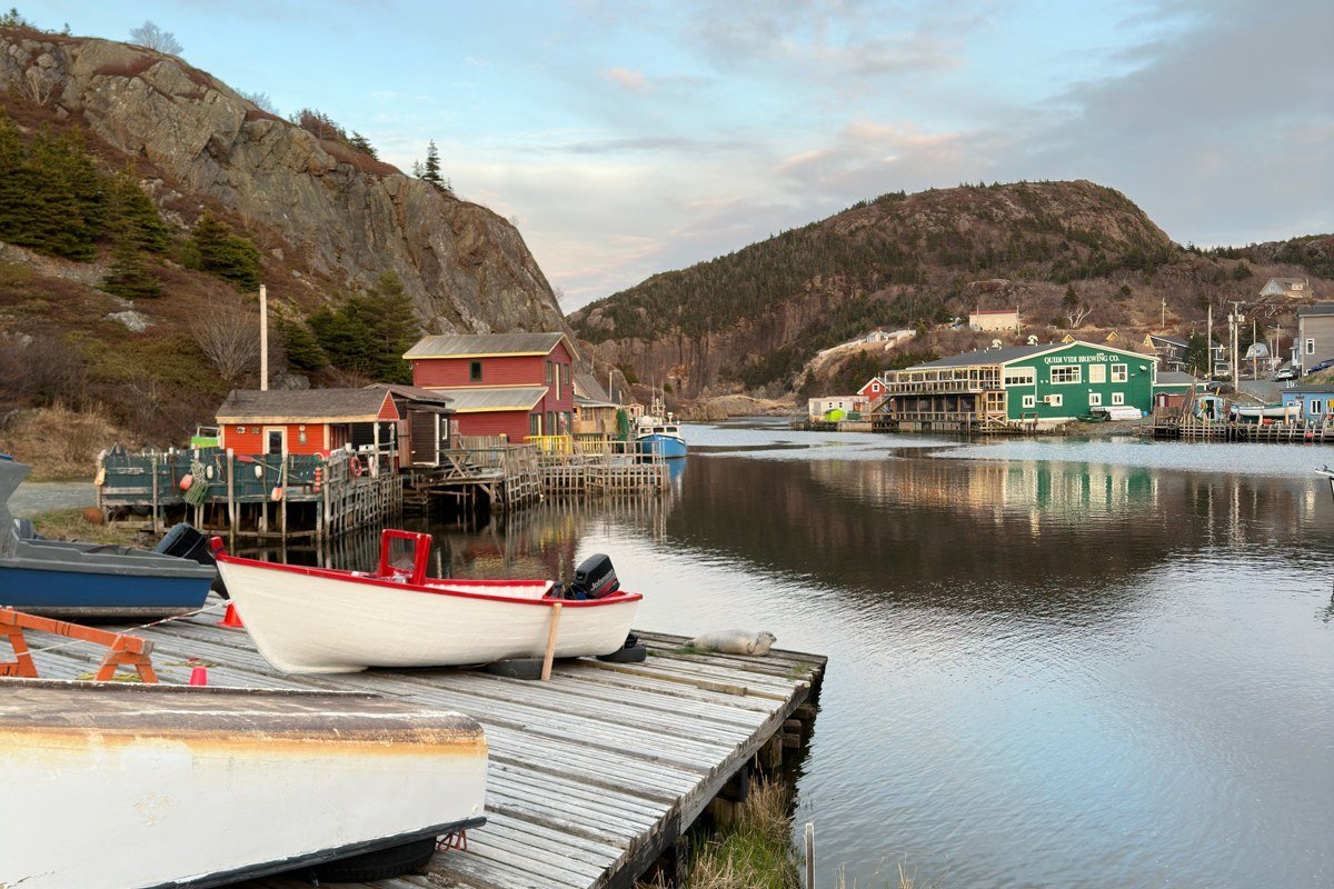 Cotuit village dock with wooden skiffs and oyster shacks in early morning light