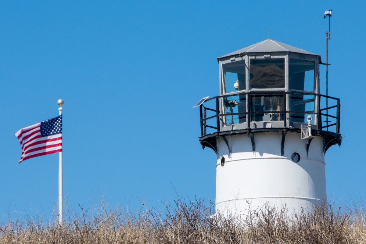 Chatham lighthouse and eroding bluff overlooking the Atlantic in golden autumn light