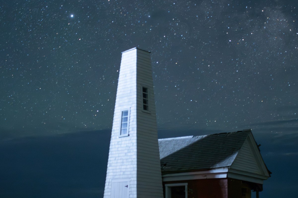 Pemaquid Point Light Bristol Maine fog rolling over striated granite ledges