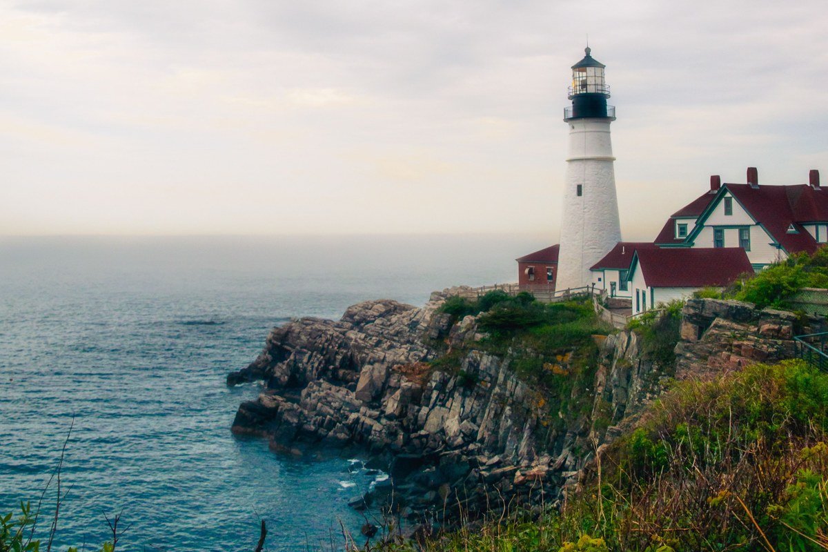 Bass Harbor Head Light Mount Desert Island Maine red-roofed tower on dark cliff fog
