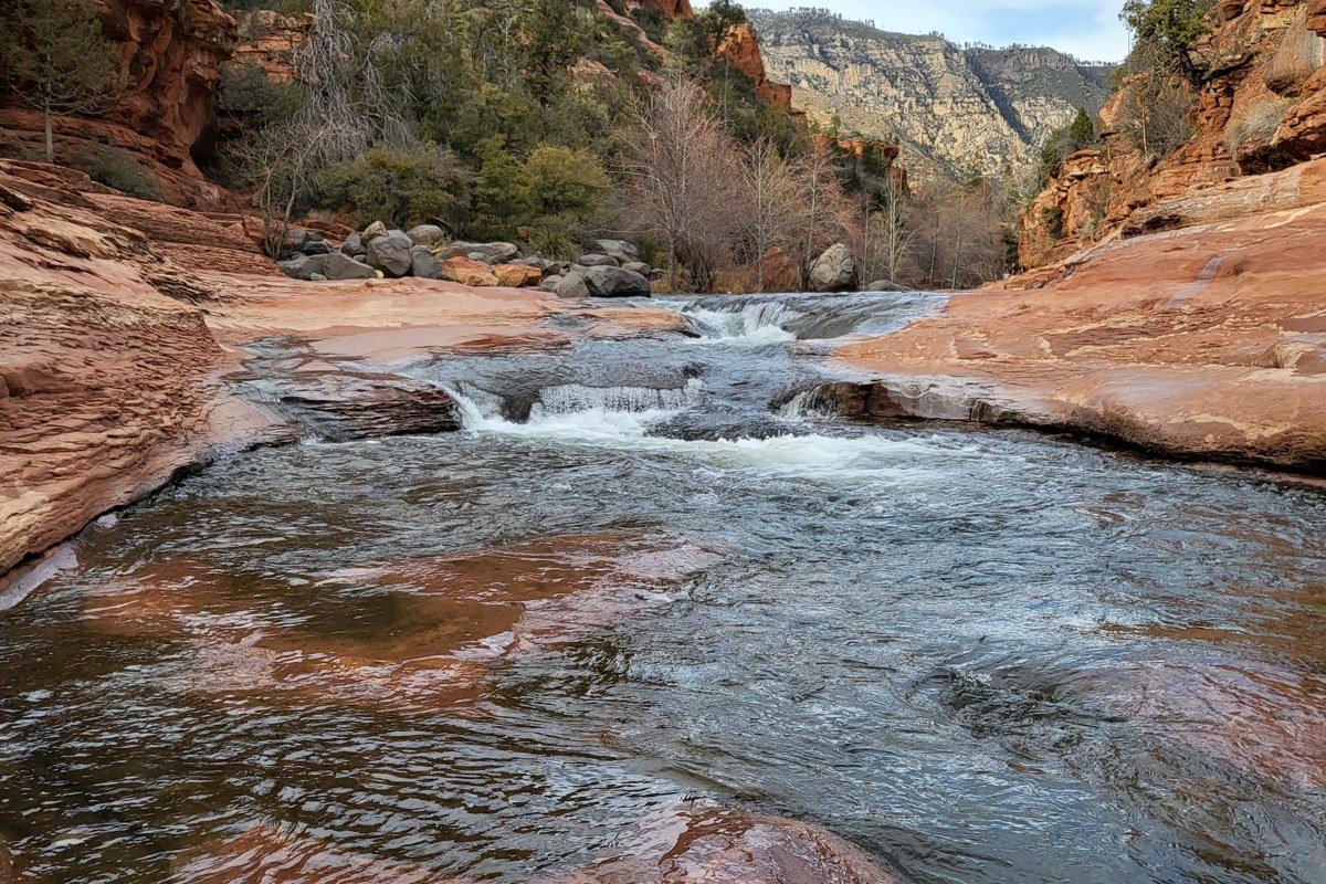 rafters punching through the standing waves at Tunnel Rapid on Clear Creek, narrow canyon walls close on both sides