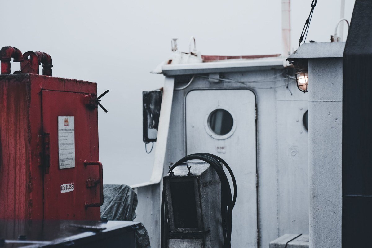 Stonington Maine working lobster harbor with stacked traps and boats in fog