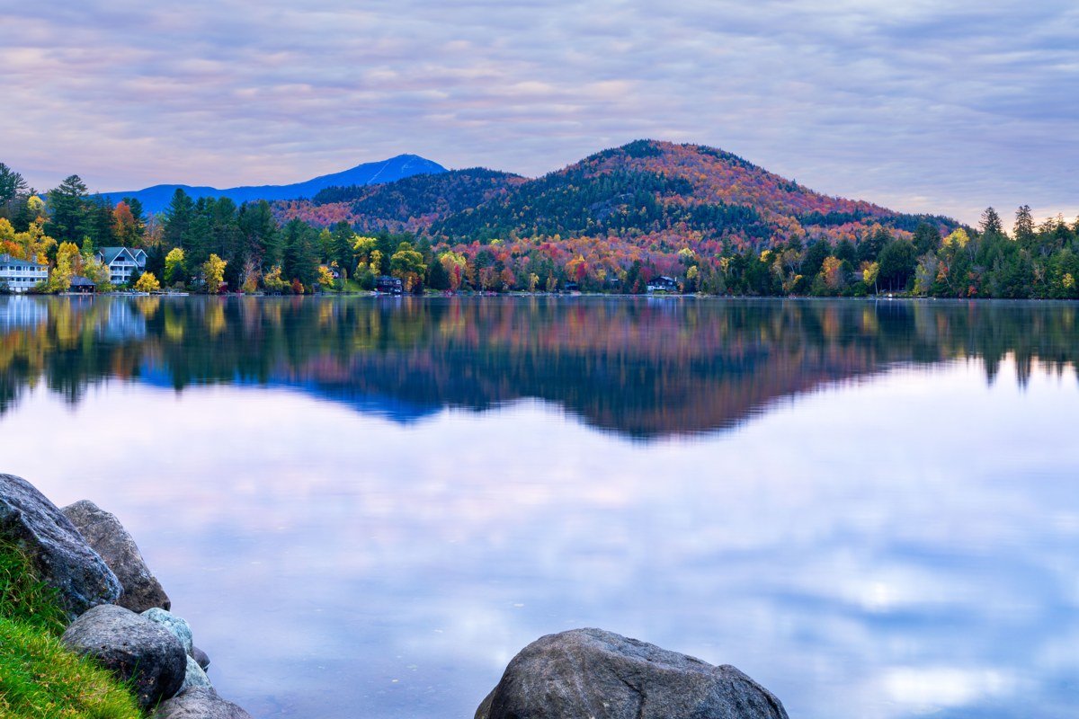 Lake Placid village and Mirror Lake at sunrise with autumn foliage