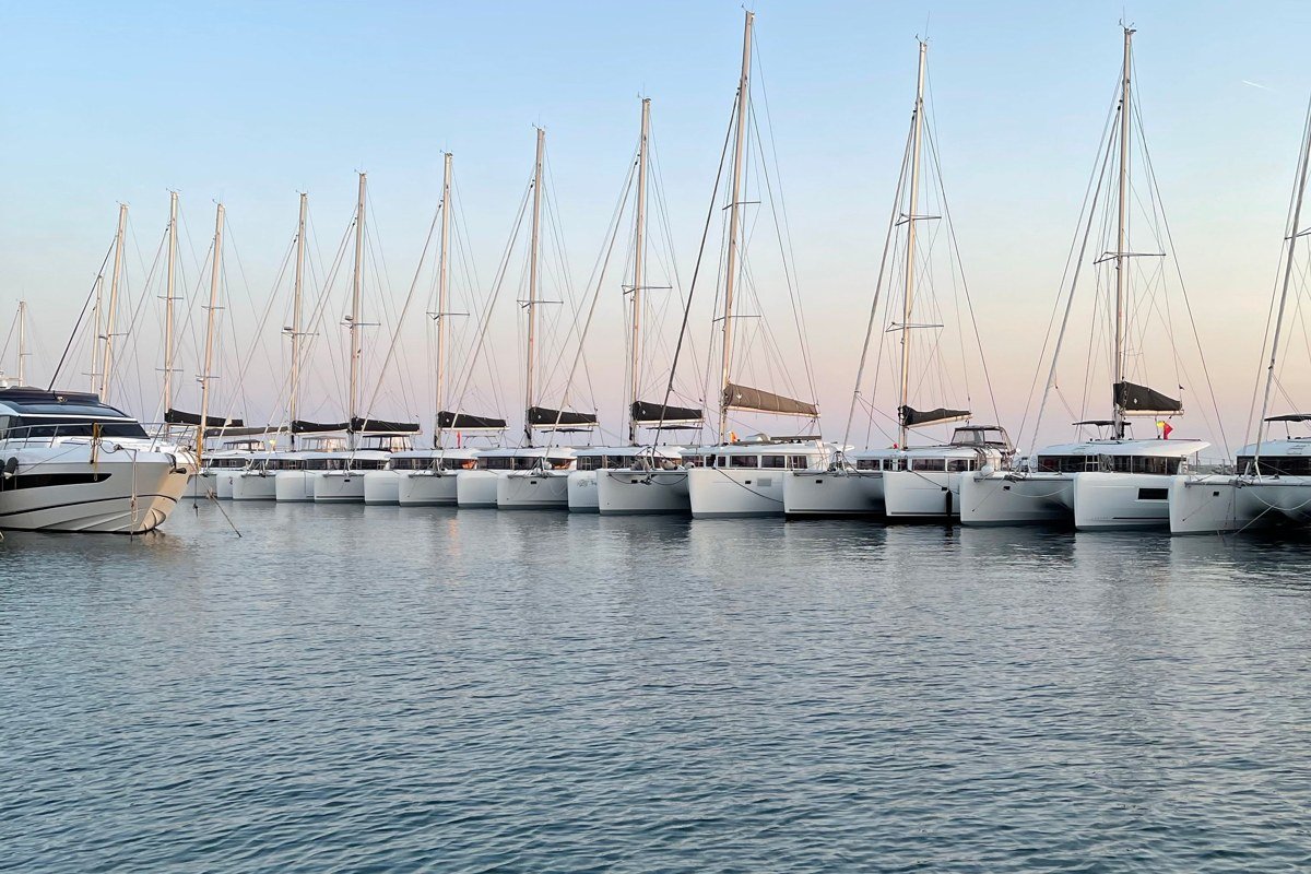 Tahoe City marina with sailboats and pine covered shoreline