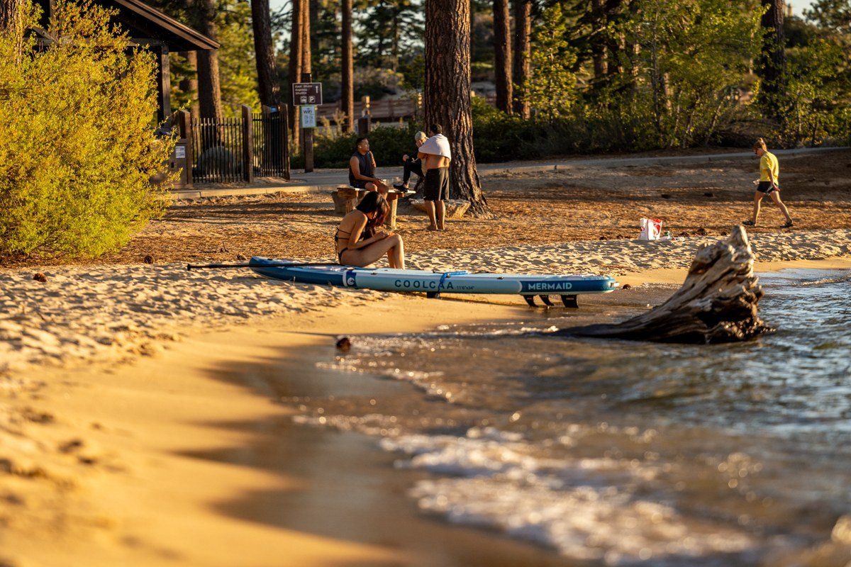 Meeks Bay Lake Tahoe sandy beach with pine trees and shallow turquoise water