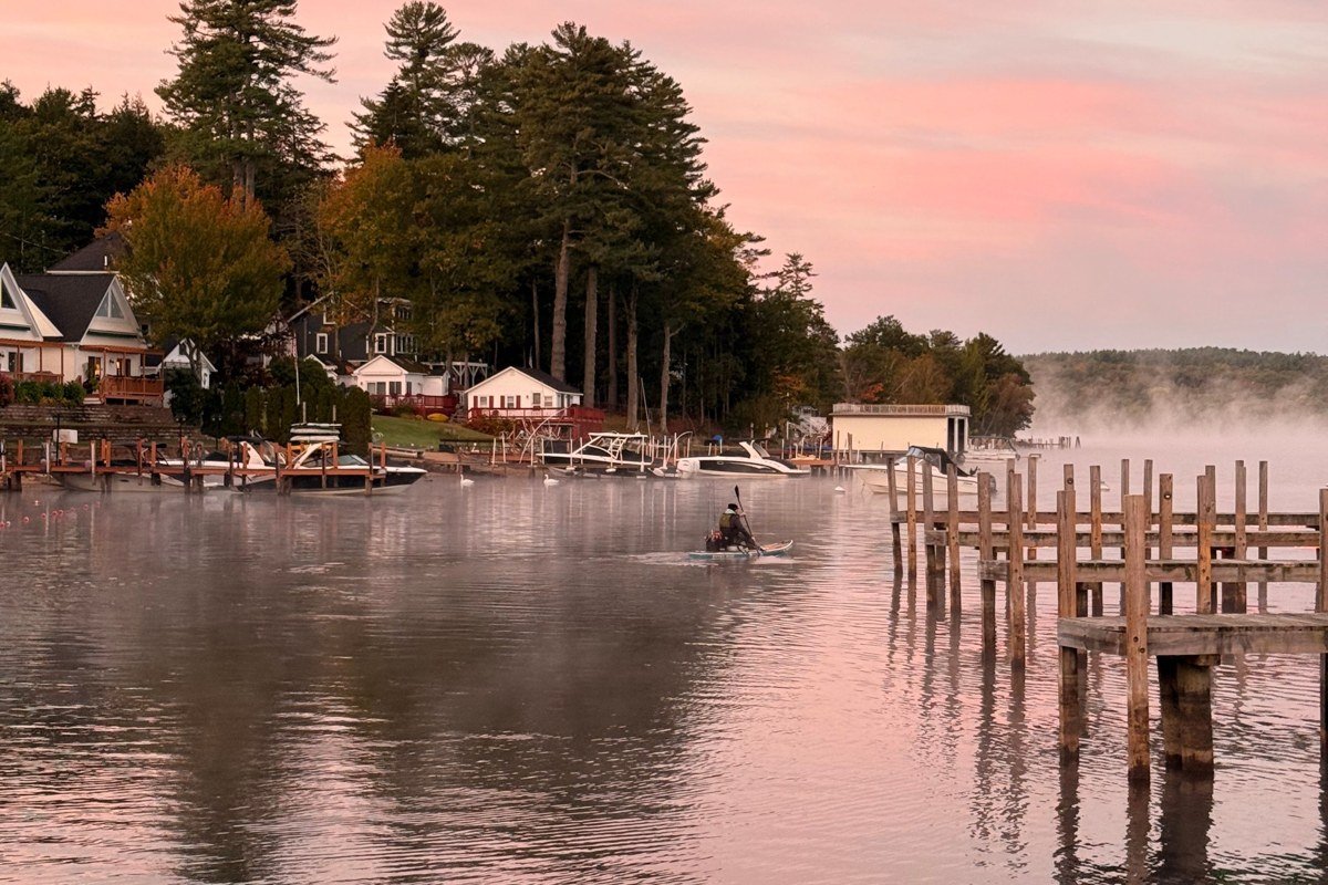 Lake Winnipesaukee New Hampshire shoreline with Mount Washington cruise boat and White Mountains in background