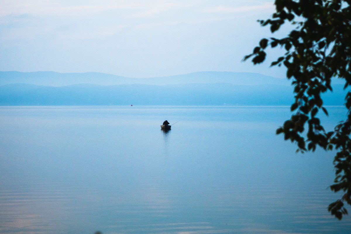 Squam Lake New Hampshire loons on still water at dawn with mountain reflection, no boats