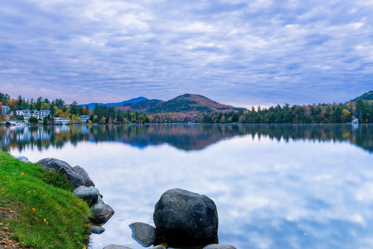 Blue Mountain Lake New York with Adirondack Museum grounds and forested islands at golden hour