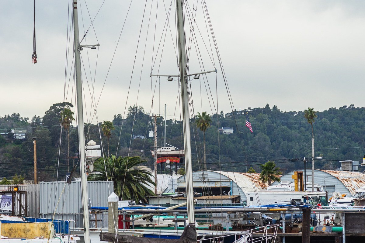 Copper Harbor marina with a single sailboat mast poking above the fog line