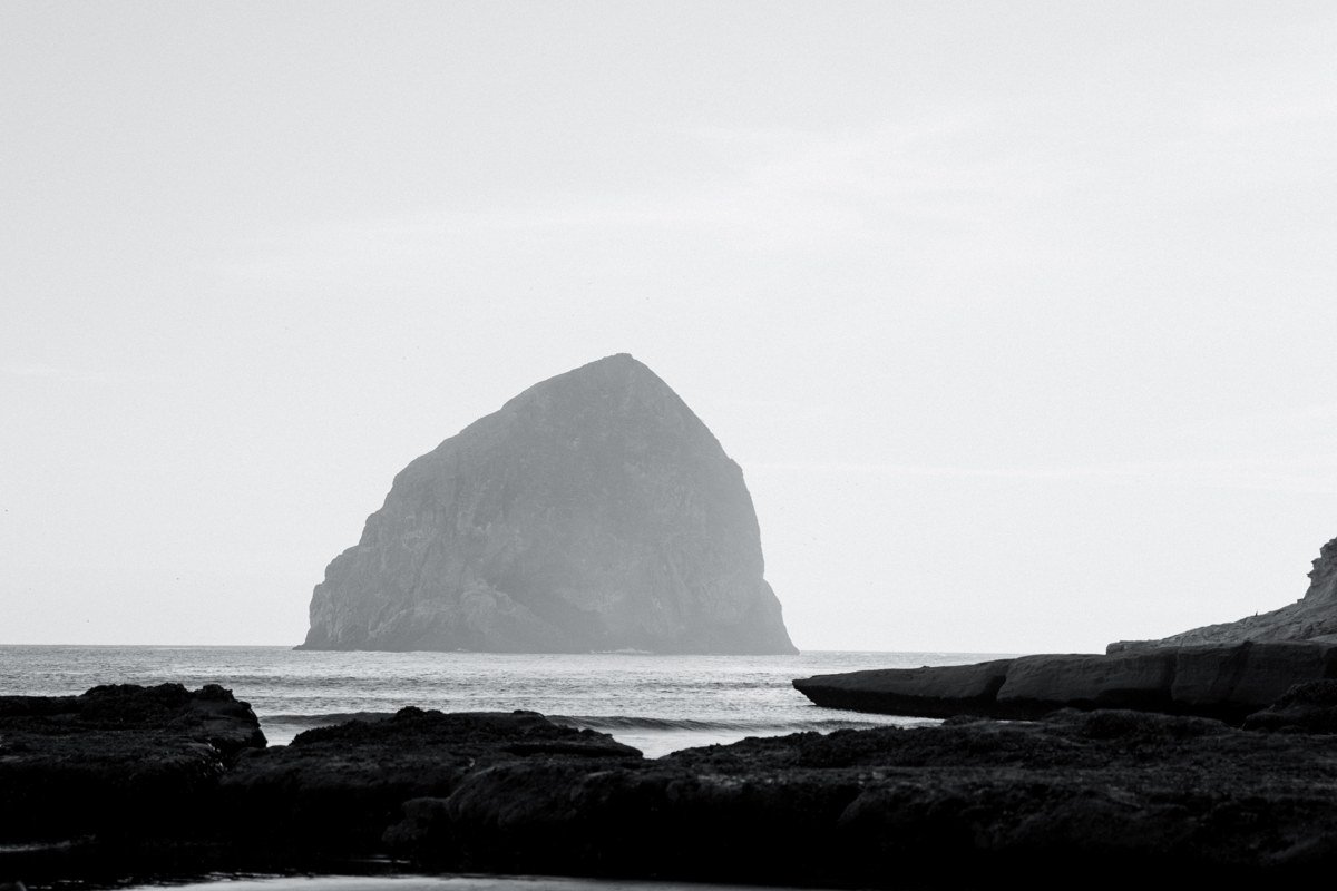Haystack Rock at Cannon Beach Oregon emerging from thick morning fog