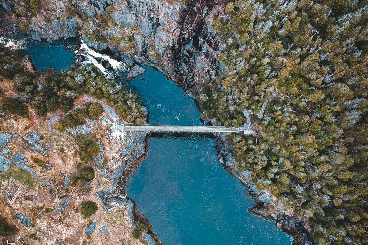 aerial view of the San Juan Islands archipelago with ferry cutting through blue water between forested islands