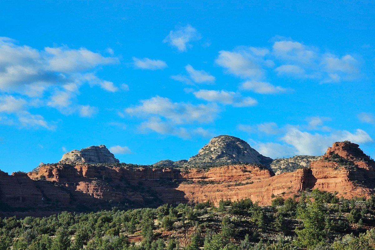 Airport Mesa overlook Sedona Arizona sunrise with red rock formations glowing orange