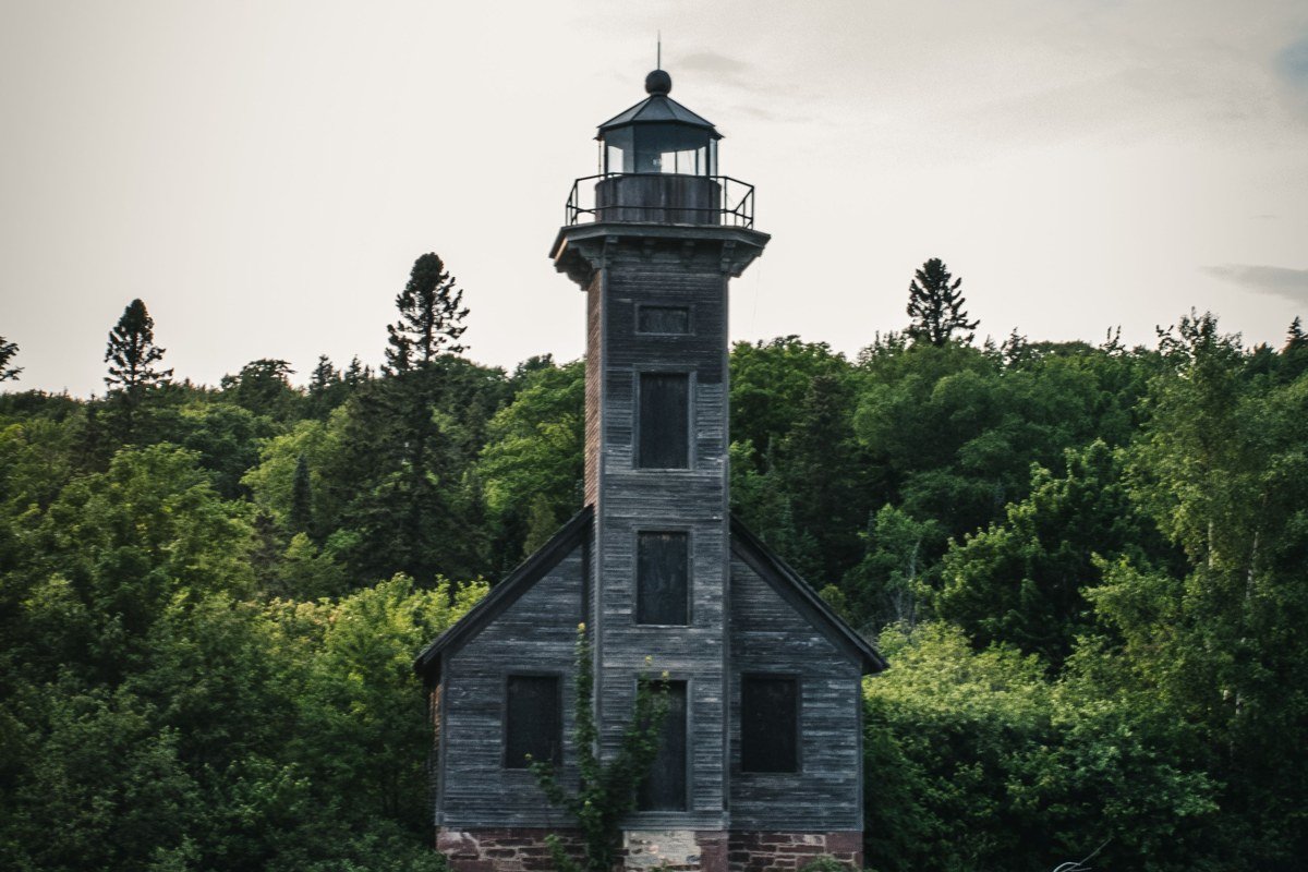 Big Bay Point Lighthouse Michigan on a fog-covered bluff above Lake Superior