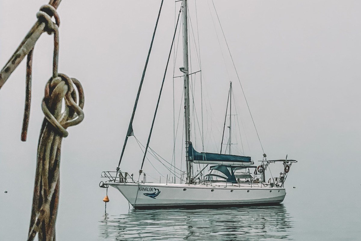 Copper Harbor Lighthouse Michigan seen from water surrounded by morning mist