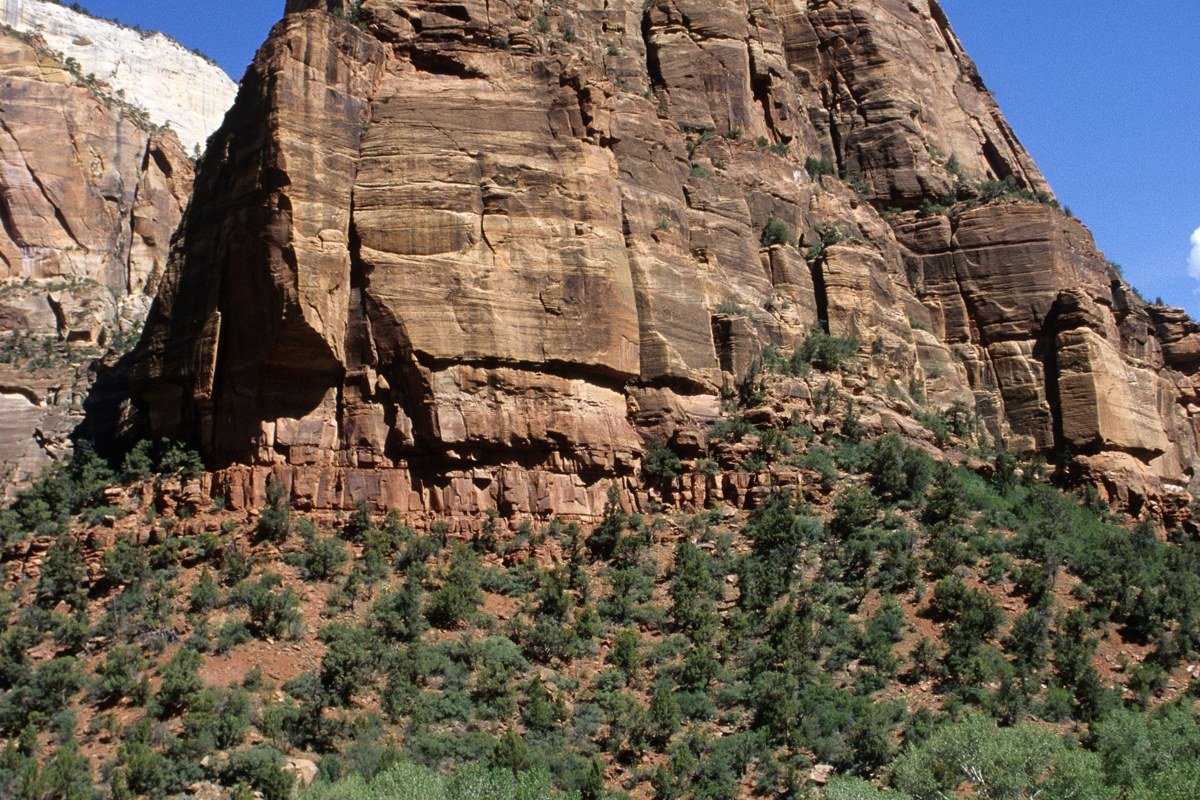 switchback tunnel road carved into red sandstone cliffs on Zion Mount Carmel Highway Utah
