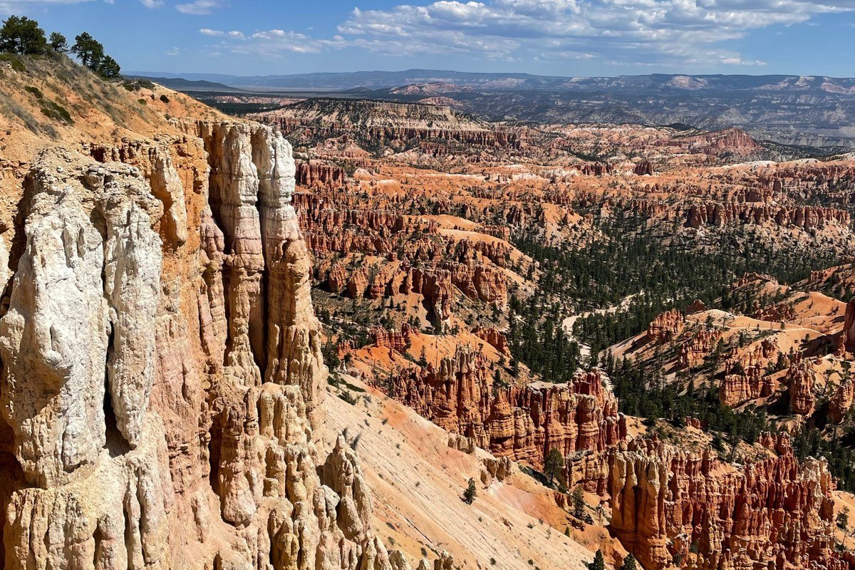 amphitheater of red and orange rock spires at Cedar Breaks National Monument Utah under a blue sky