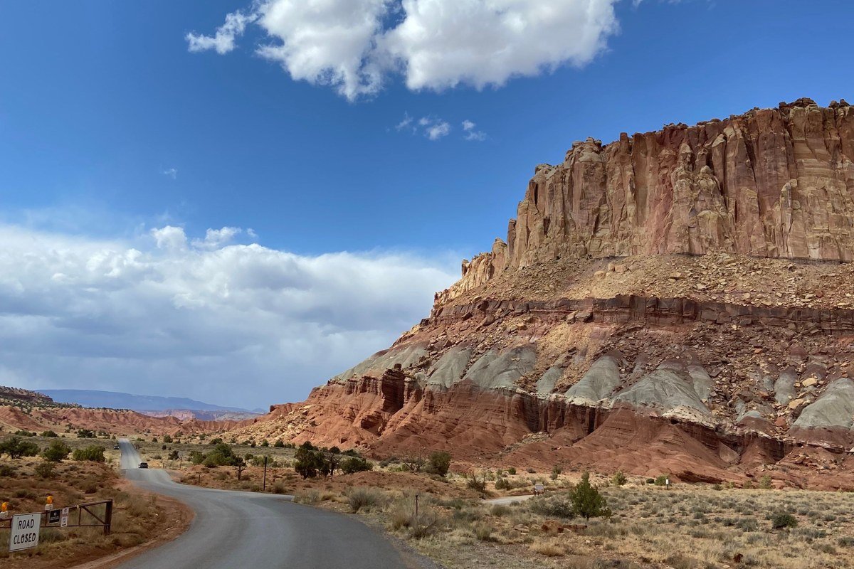 small town street in Escalante Utah with slot canyon terrain visible in the surrounding desert