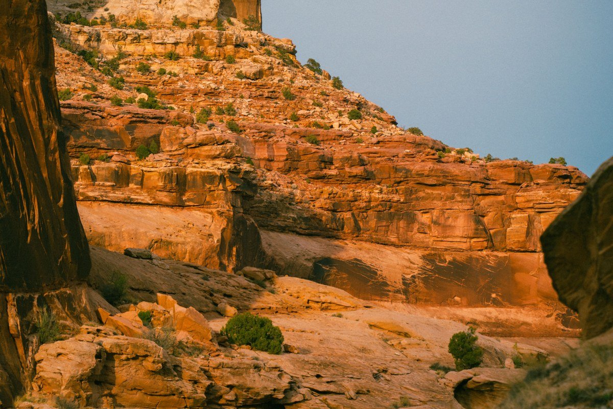 layered red and tan rock canyons of the San Rafael Swell Utah seen from a highway overlook