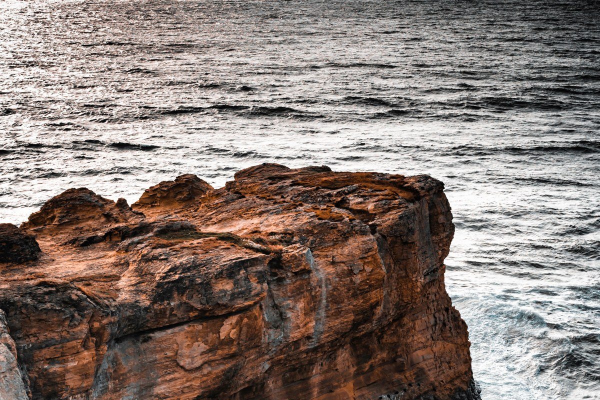 waves breaking against the sea caves below Cape Flattery, the cliff edge barely visible