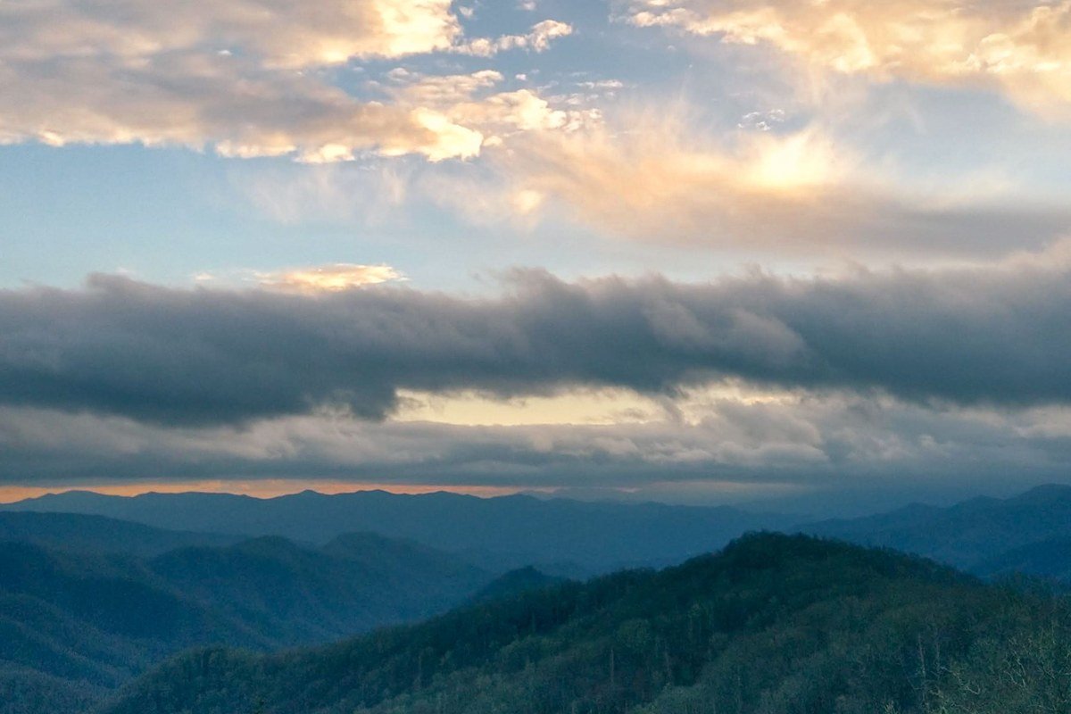 Gatlinburg Spur overlook sunrise smoky fog rising above Pigeon Forge valley Tennessee