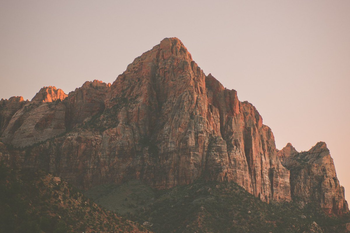 Emerald Pools trail Zion National Park waterfall over red rock with early morning light