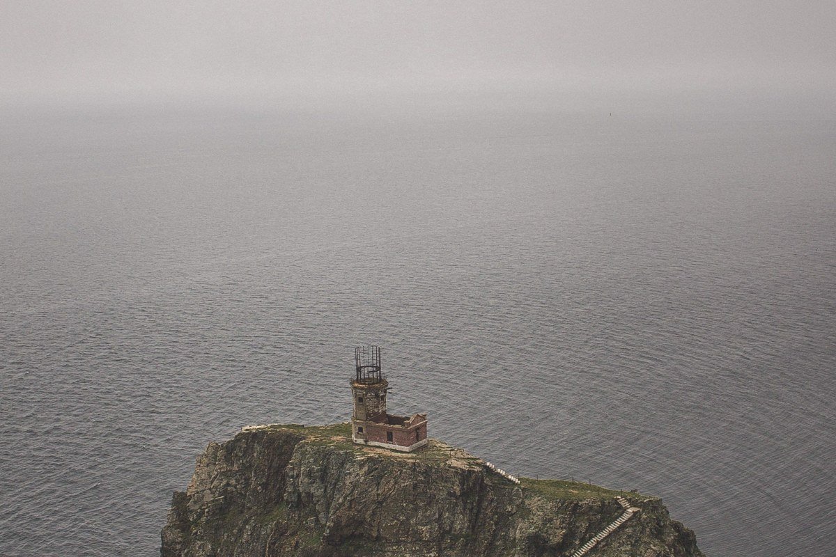 Monhegan Island lighthouse cliffs shrouded in fog, Maine