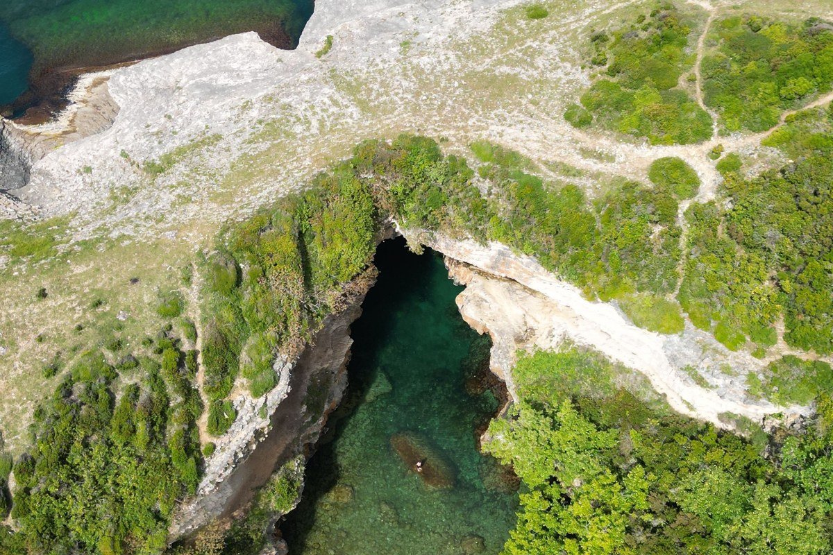 aerial view of Apostle Islands archipelago Lake Superior with sea caves and forested shoreline at sunset