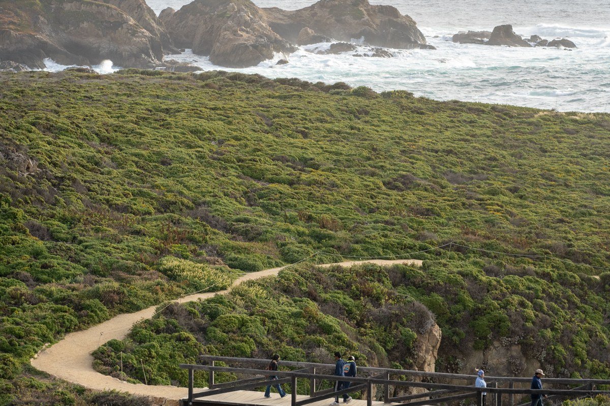 Bixby Bridge arching over Big Sur canyon with ocean cliffs in background, California