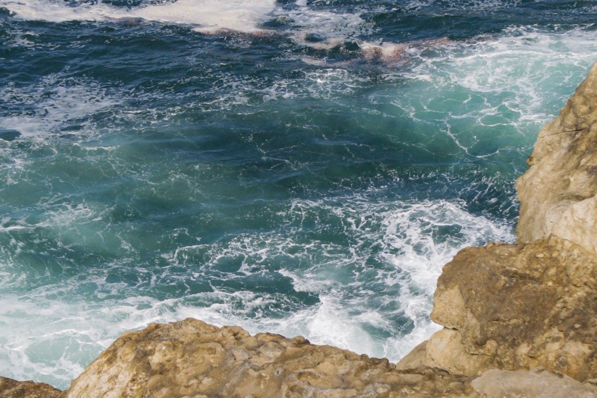 Hurricane Point vista with exposed cliffside pullout and whitecapped Pacific waves, California