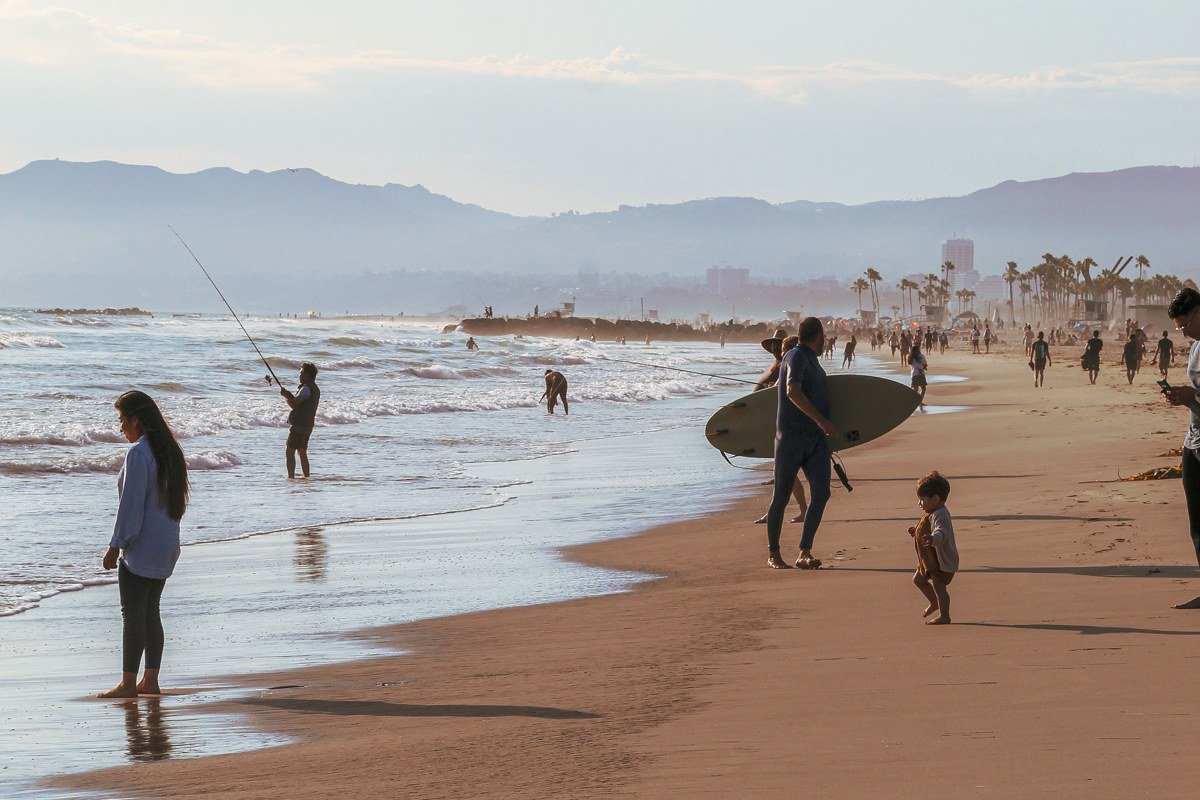Carpinteria California State Beach with families and mountains behind