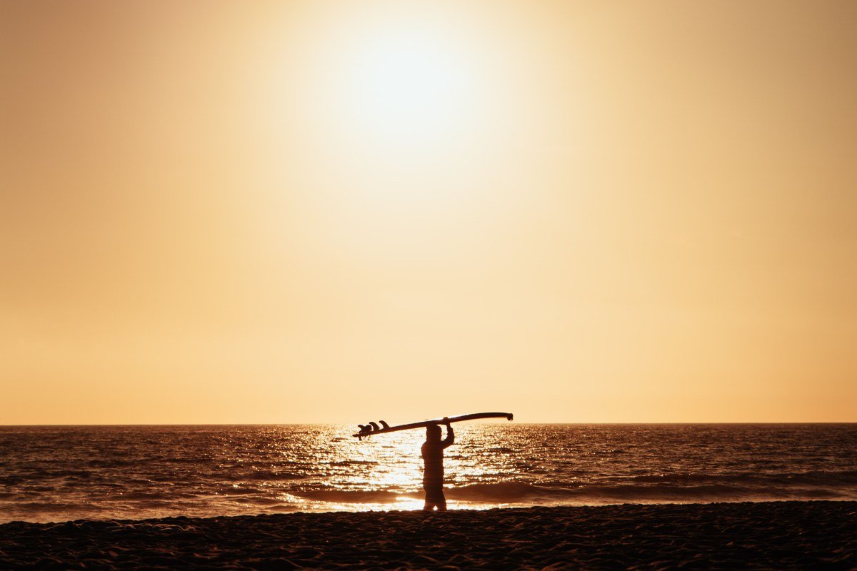Cardiff-by-the-Sea California surf beach with sunset and silhouetted surfers