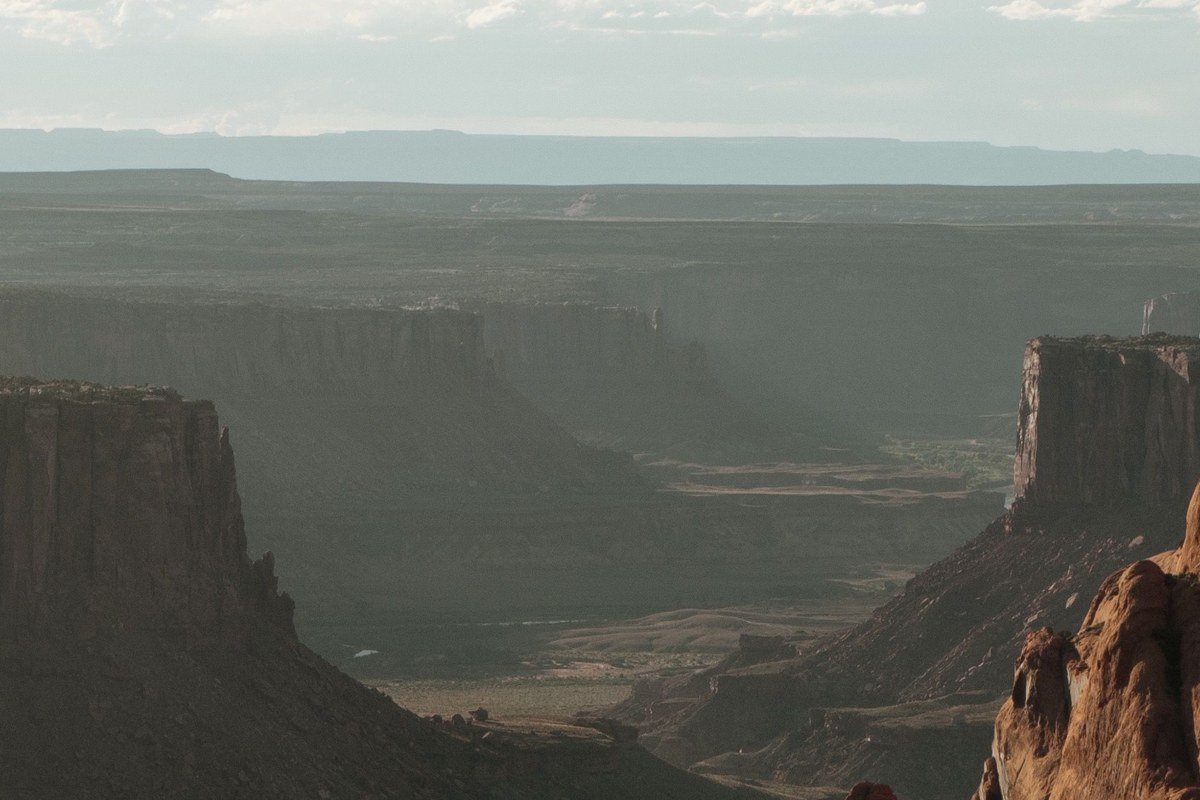 Green River Overlook Canyonlands at golden hour with orange sandstone cliffs and winding river canyon below