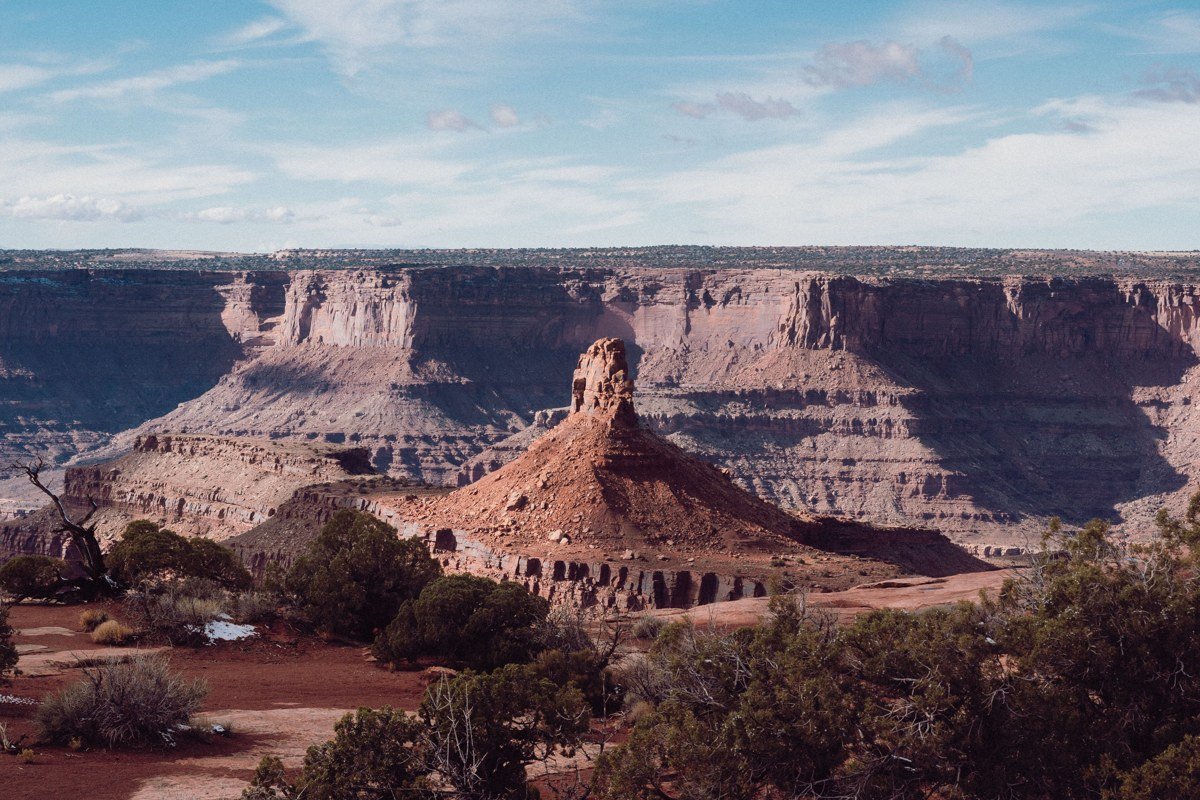 White Rim Overlook Canyonlands showing the White Rim Road as a thin ribbon cutting through pale sandstone terrain